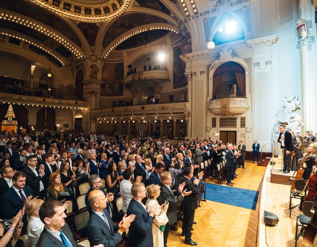 Concert hall audience applauding an orchestra